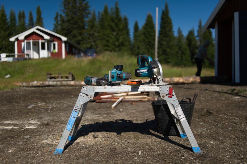 Cordless drill and circular saw set on a jobsite worktable